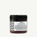Davines Alchemic Conditioner Tobacco in a dark amber jar with a black ribbed lid and white label.