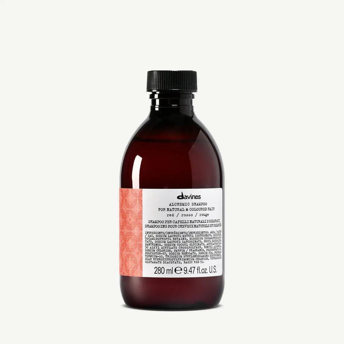 Davines Alchemic Shampoo Red, a dark amber bottle with a black cap and red patterned label.