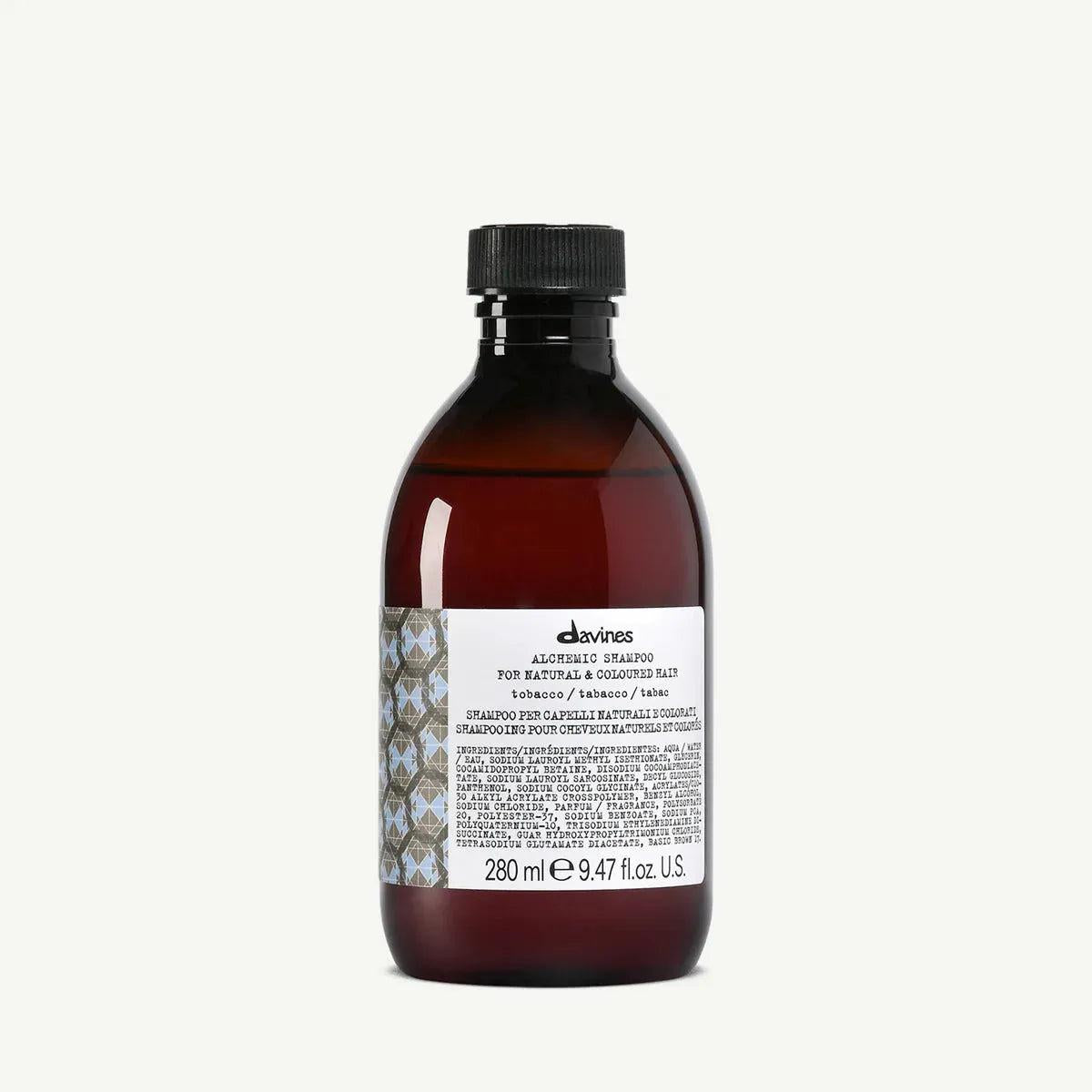Davines Alchemic Shampoo Tobacco, a dark amber bottle with a black cap and white label.