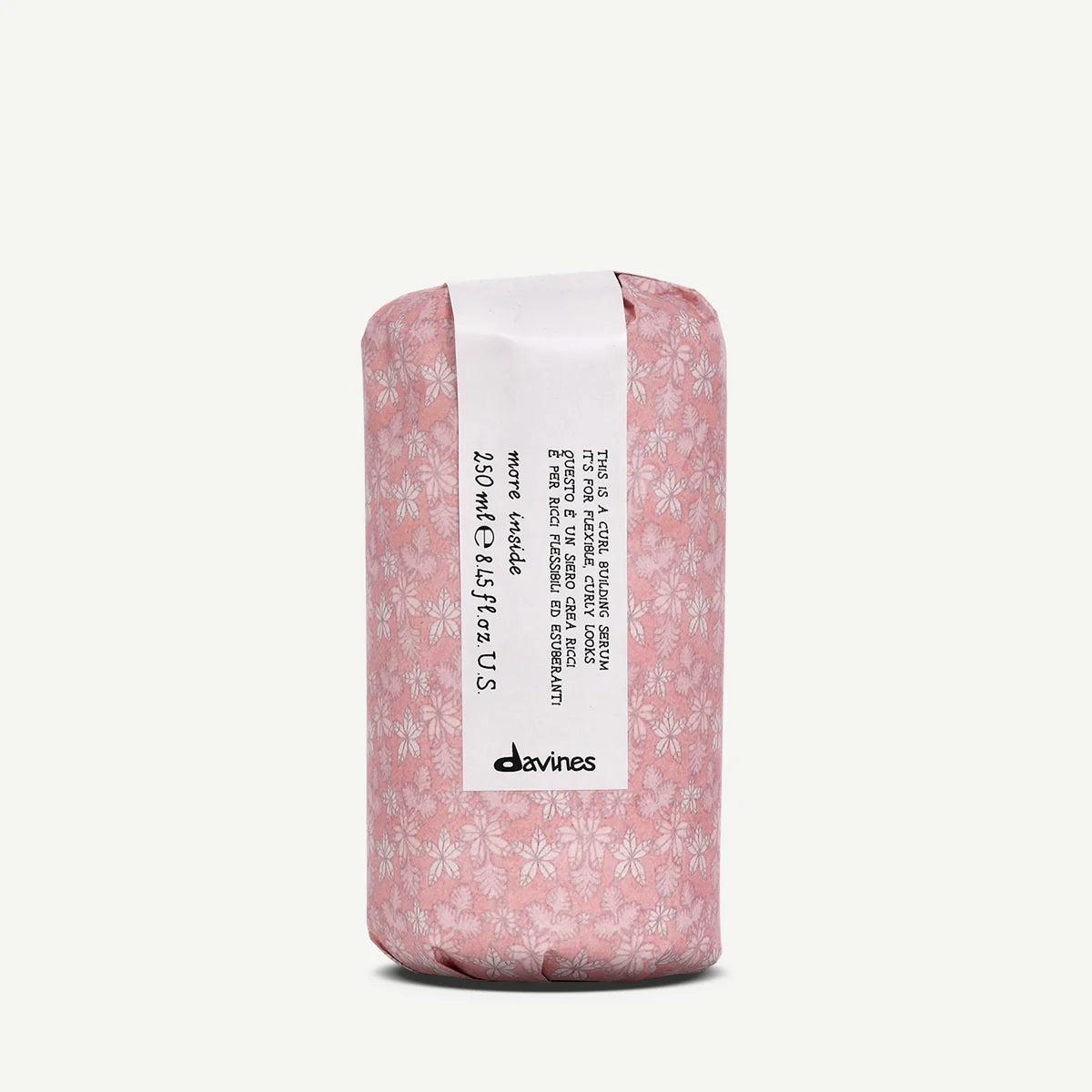 Davines Curl Building Serum, 250ml, wrapped in pink floral paper with a white label.