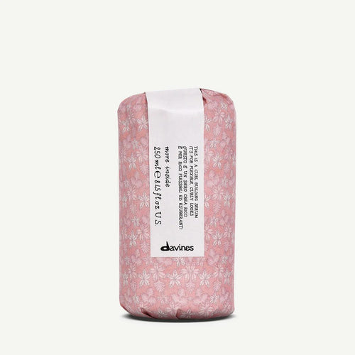 Davines Curl Building Serum, 250ml, wrapped in pink floral paper with a white label.