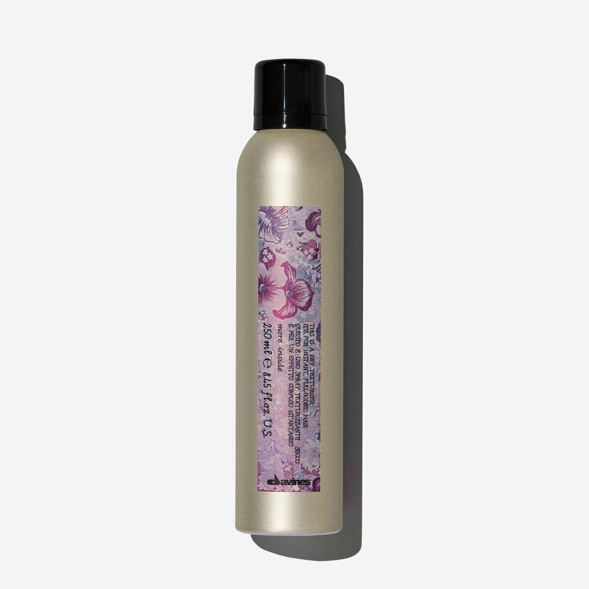 Davines Dry Texturizer, 250ml gold aerosol can with a black cap and purple floral label.
