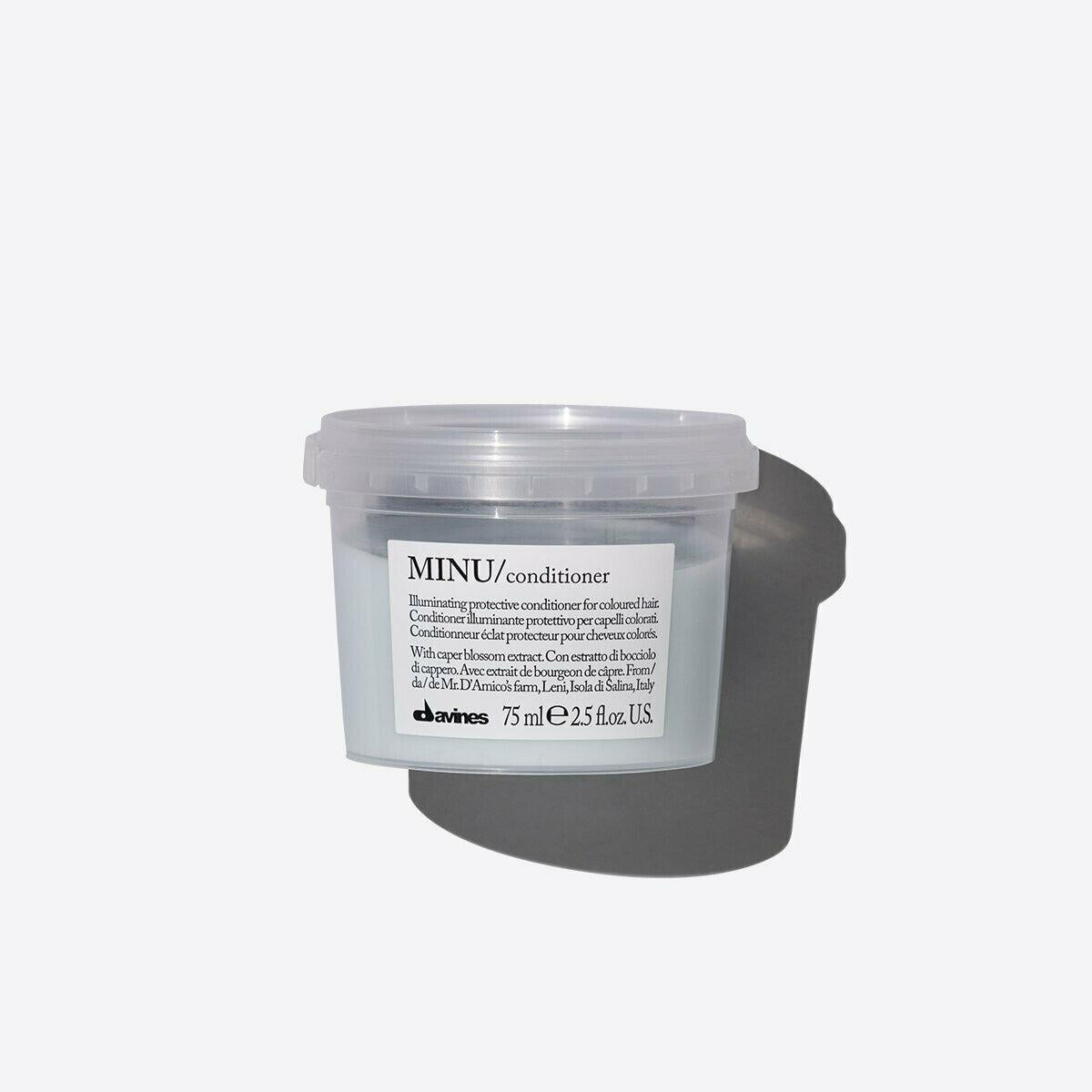 Davines MINU Conditioner 75ml in a clear plastic tub with a light blue label, casting a shadow.