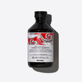 Davines NaturalTech Energizing Shampoo, a 250ml black bottle with a red and white dragon design.