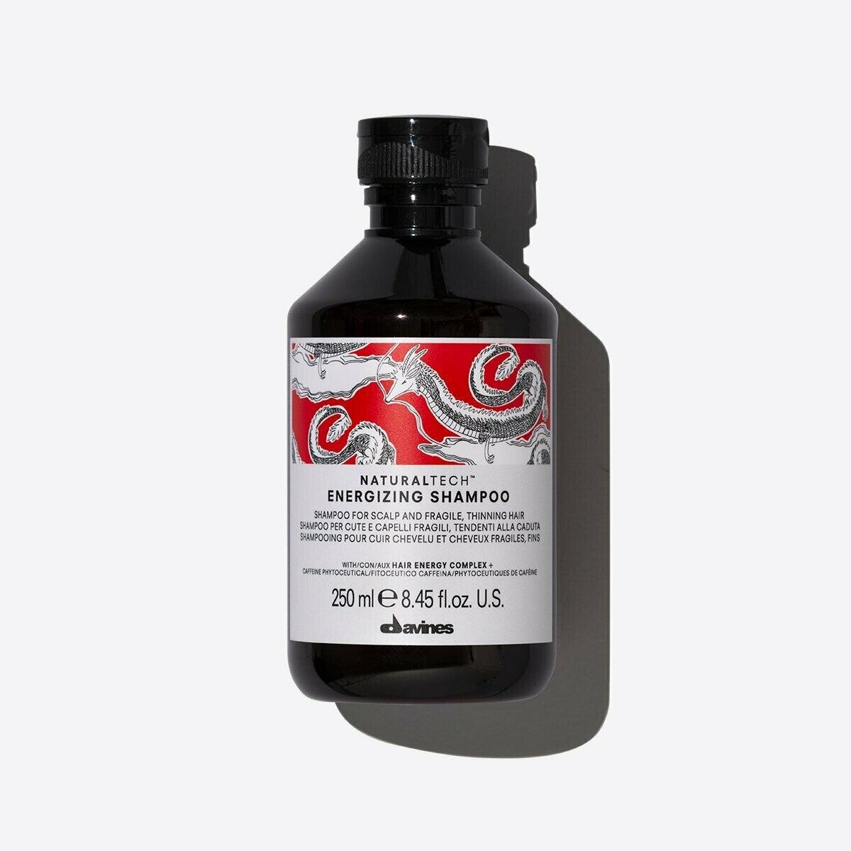 Davines NaturalTech Energizing Shampoo, a 250ml black bottle with a red and white dragon design.