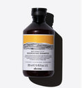 Davines NaturalTech Nourishing Shampoo, 250ml dark amber bottle with a black cap and yellow label.