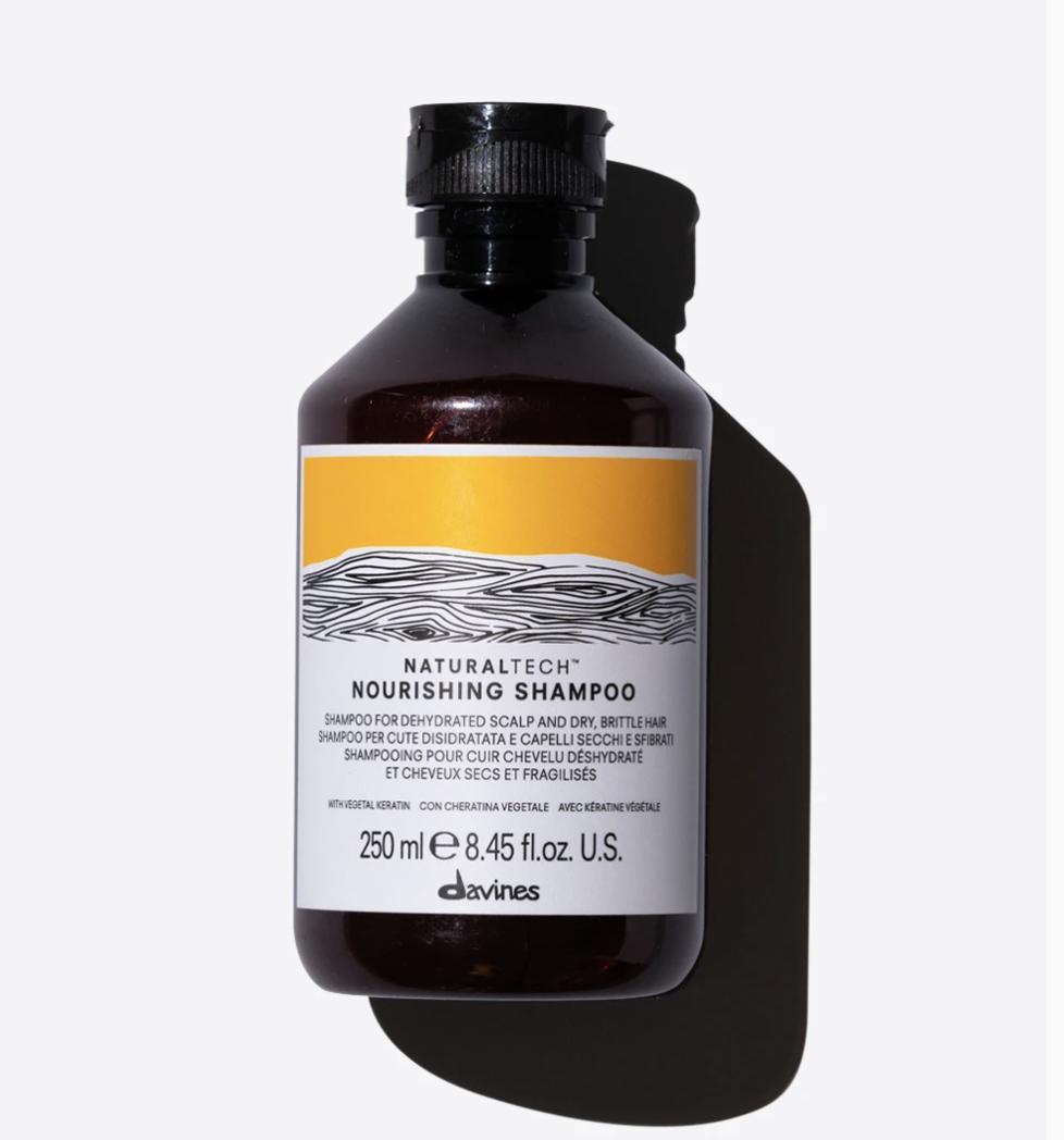 Davines NaturalTech Nourishing Shampoo, 250ml dark amber bottle with a black cap and yellow label.