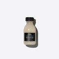 Davines OI Shampoo 90ml bottle with a black cap and label on a white background.