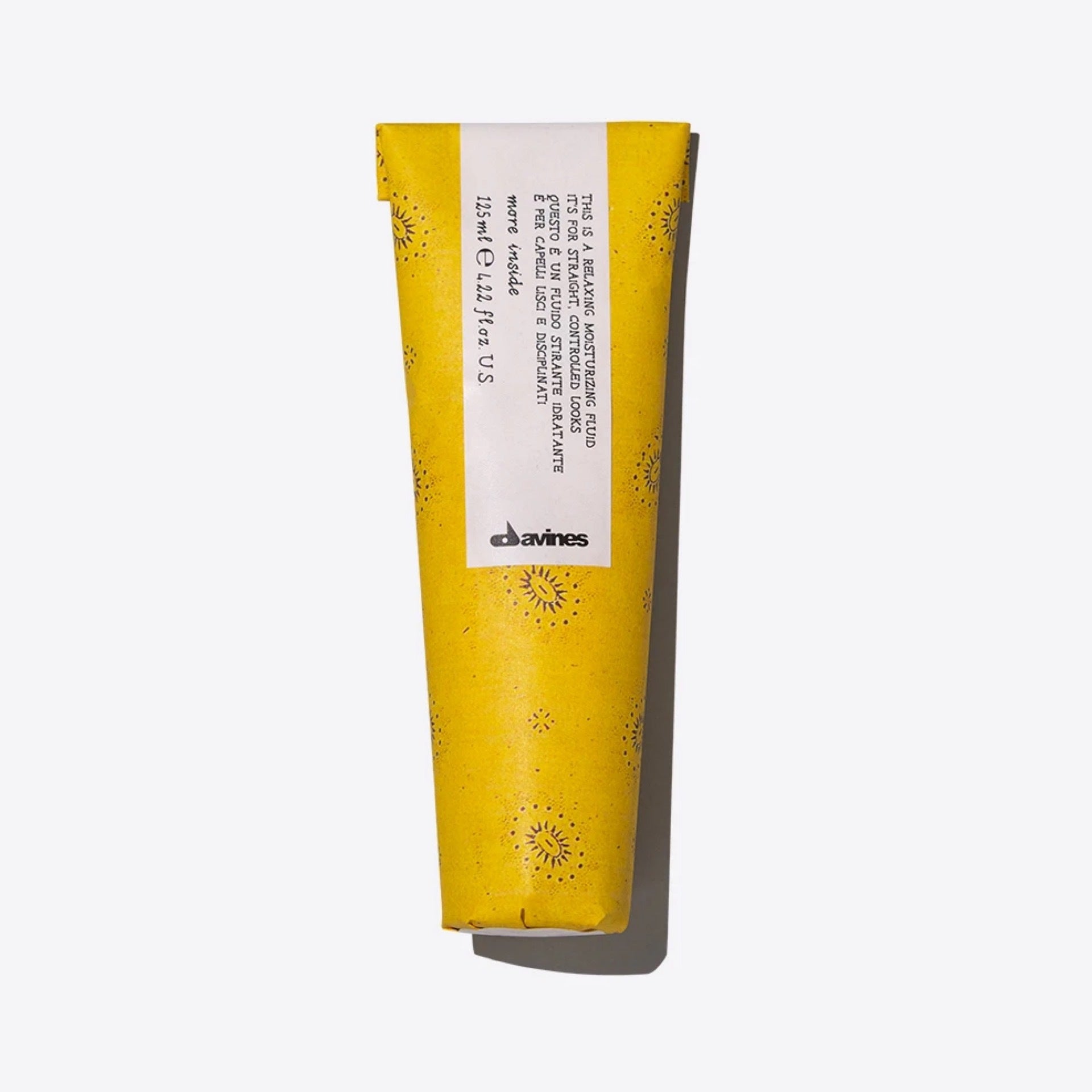 Davines Relaxing Moisture Fluid in a yellow 125ml tube with small sunburst patterns.