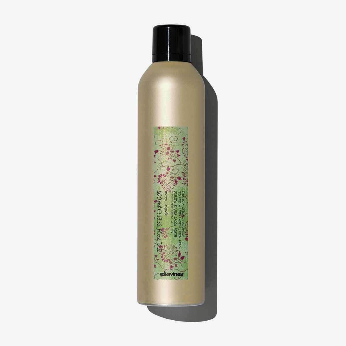 Davines Strong Hold Hair Spray in a 400ml gold aerosol can with a black cap and green floral label.