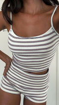 Woman wearing a white striped Fairfield 2-piece set with red and blue stripes, polyester-spandex blend.
