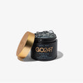 GO24•7 Pomade in a black jar with a gold lid, showing the clear, high-shine hair product.