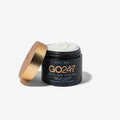 GO24•7 Styling Cream in a matte black jar with a gold lid, open to reveal white cream.