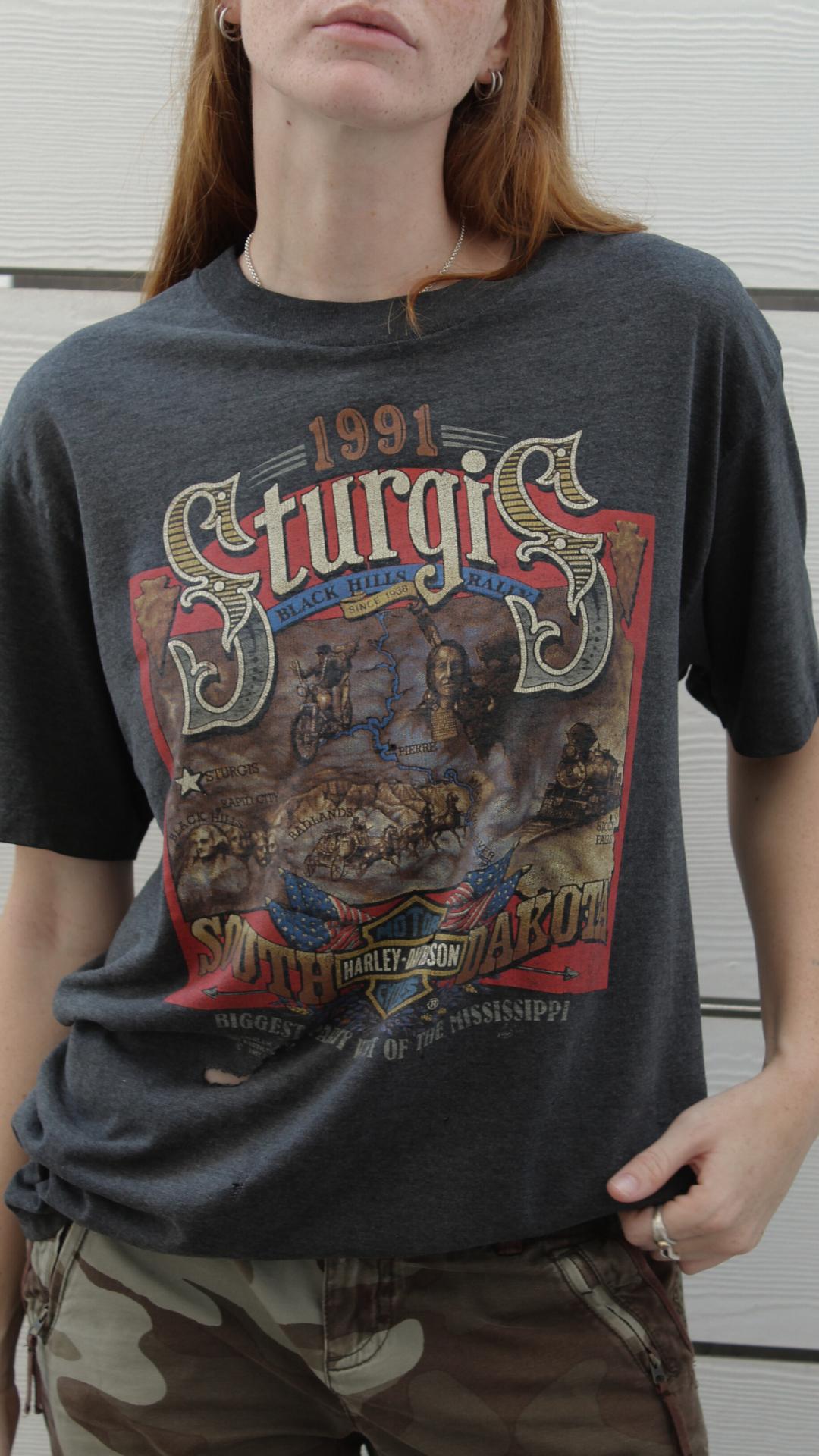 Dark gray Harley Davidson Sturgis Black Hills Rally tee with a colorful 1991 graphic.