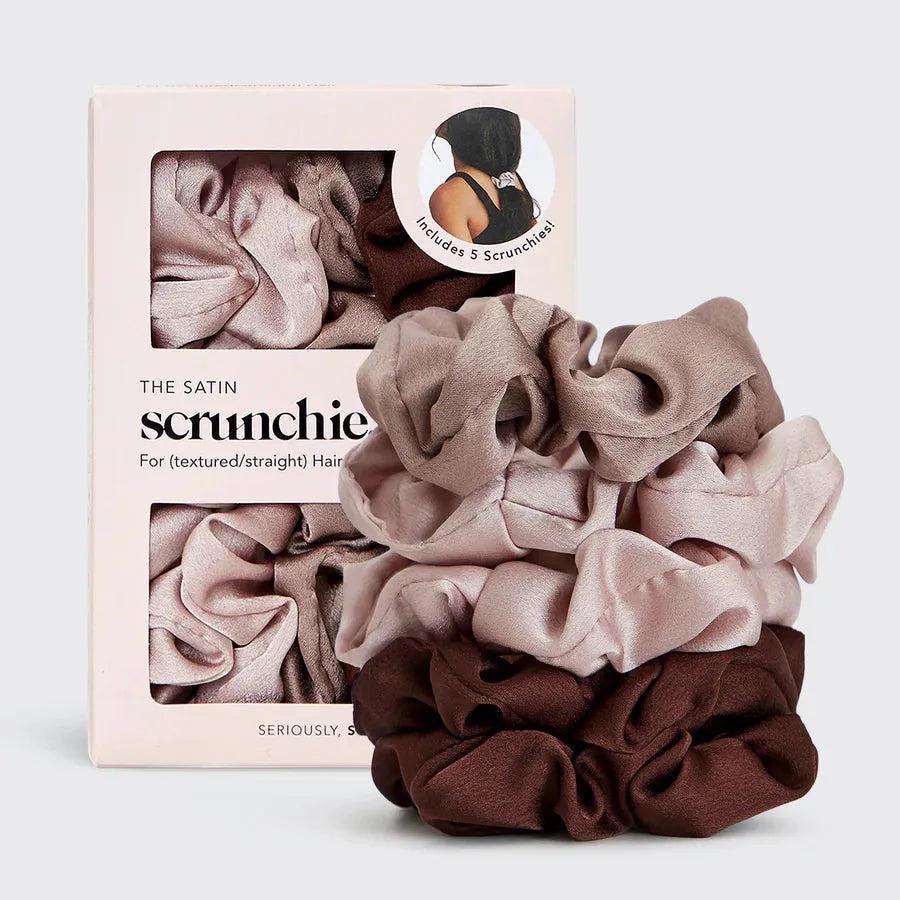 Kitsch 5pc satin scrunchies in shades of brown and pink, stacked next to their packaging.