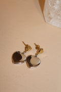 Silver and gold heart-shaped drop earrings with gold studs.