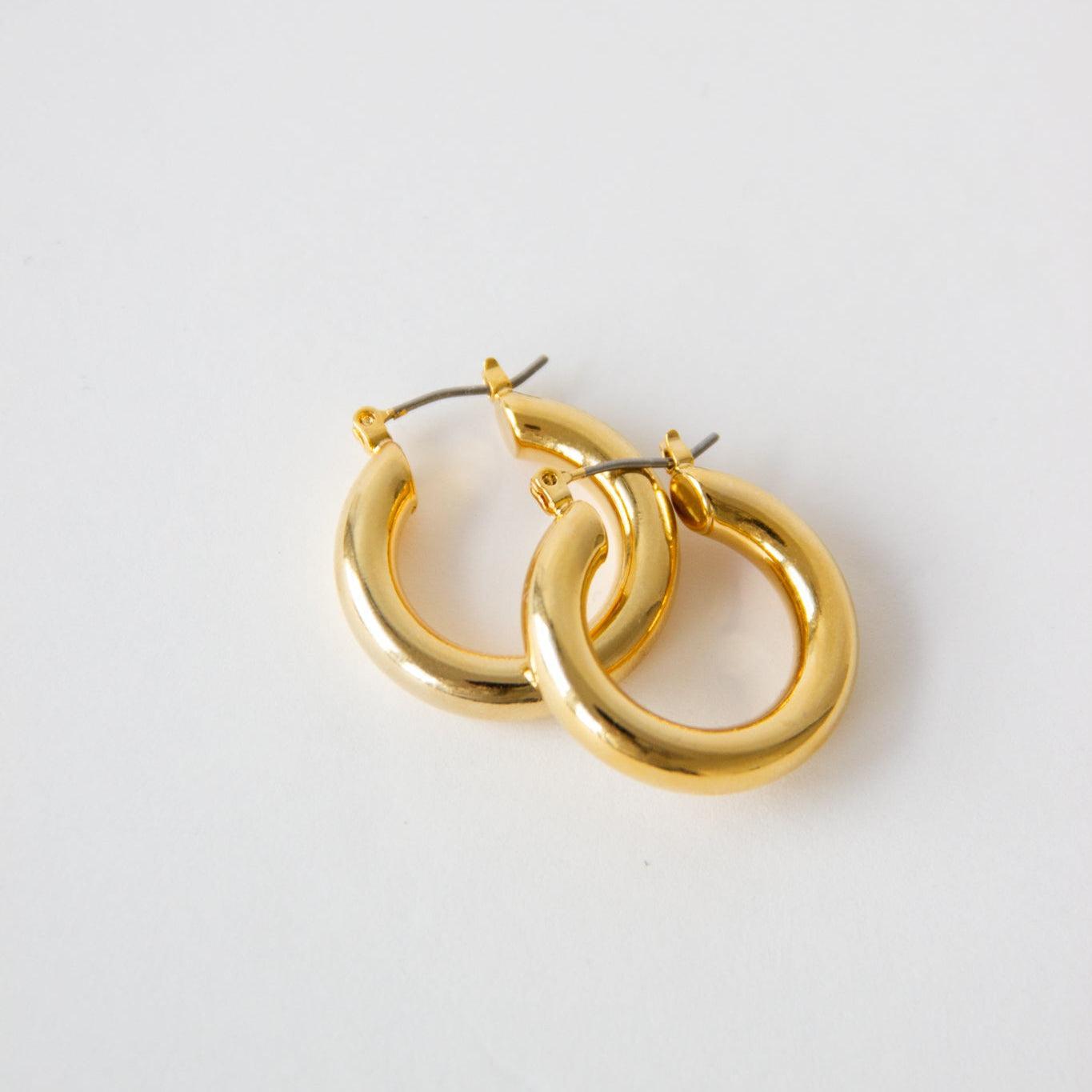 Pair of shiny gold mini thicc hoop earrings with a polished finish.