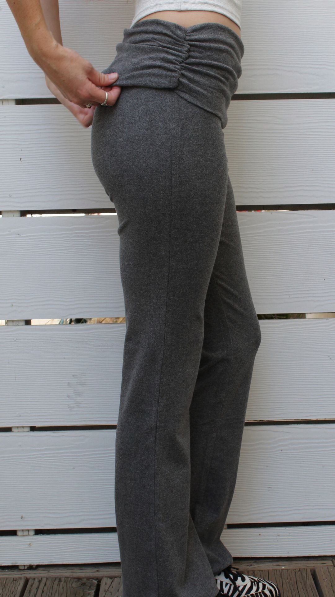 Montauk Pant: Model in charcoal rayon-spandex pants with ruched waistband.