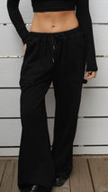 Black 100% cotton carpenter sweatpants with drawstring waist, worn by a model in size S.