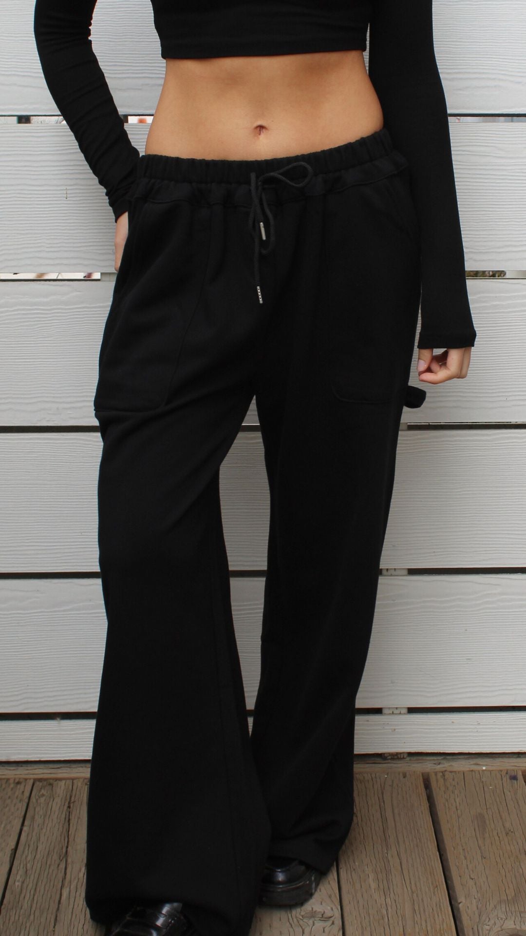 Black 100% cotton carpenter sweatpants with drawstring waist, worn by a model in size S.