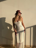 Liana in a cream knitted Piña Dress with a net pattern bottom, wearing sunglasses and a bandana.