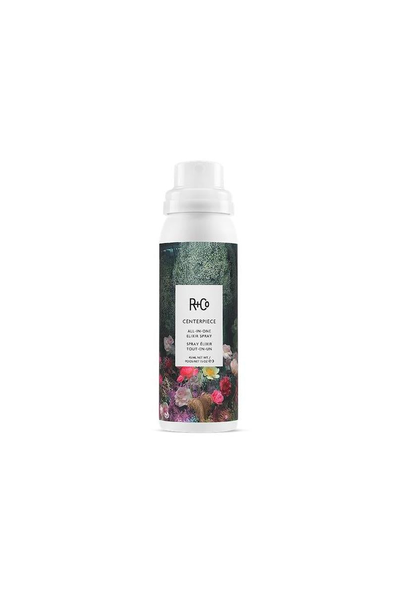 R+Co Centerpiece All-In-One Elixir Spray MINI, a white 1.5 oz bottle with a dark floral design.