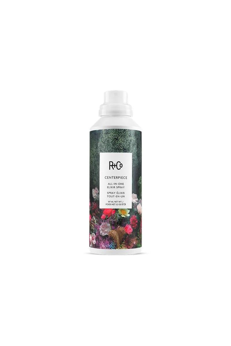 R+Co Centerpiece All-In-One Elixir Spray, 5.2 oz white bottle with a dark floral and forest design.