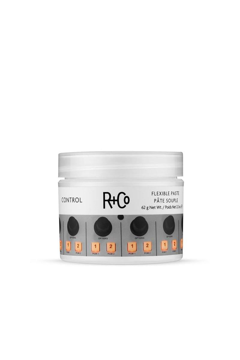 White R+Co Control Flexible Paste jar, 2.2 oz, with a grey label featuring black knobs and orange buttons.