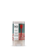 R+Co Dart Pomade Stick, a white and teal tube with a red dart hitting a target design.