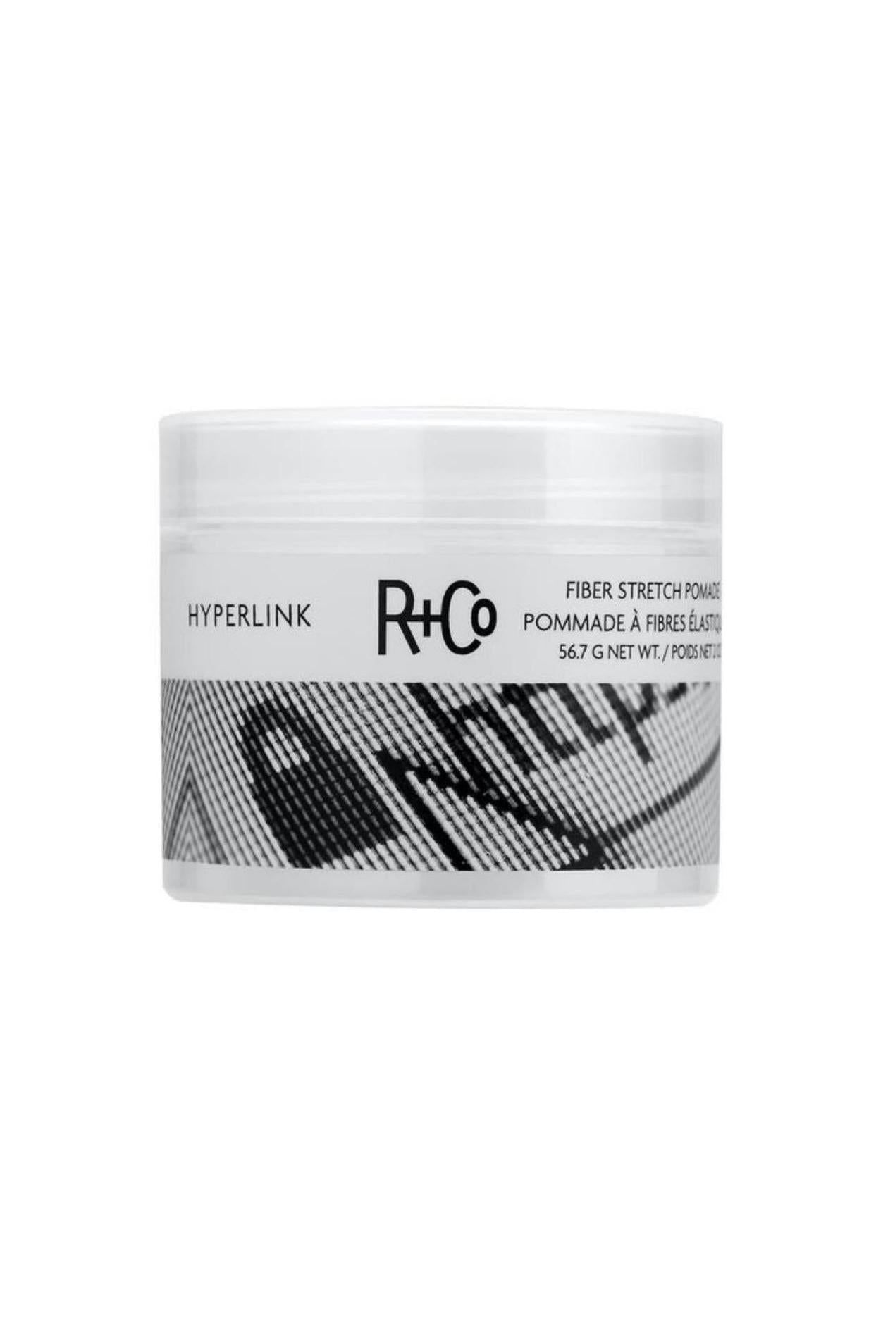 White R+Co Hyperlink Fiber Stretch Pomade jar, 56.7g, with black text and a textured graphic.
