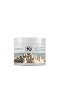 R+Co Sand Castle Dry Texture Creme in a clear jar with a sandcastle and ocean label.