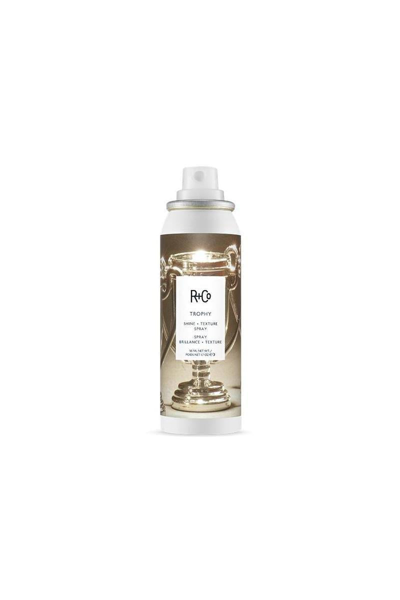 R+Co Trophy Shine & Texture Spray MINI 1.7 oz, white can with a metallic trophy graphic.