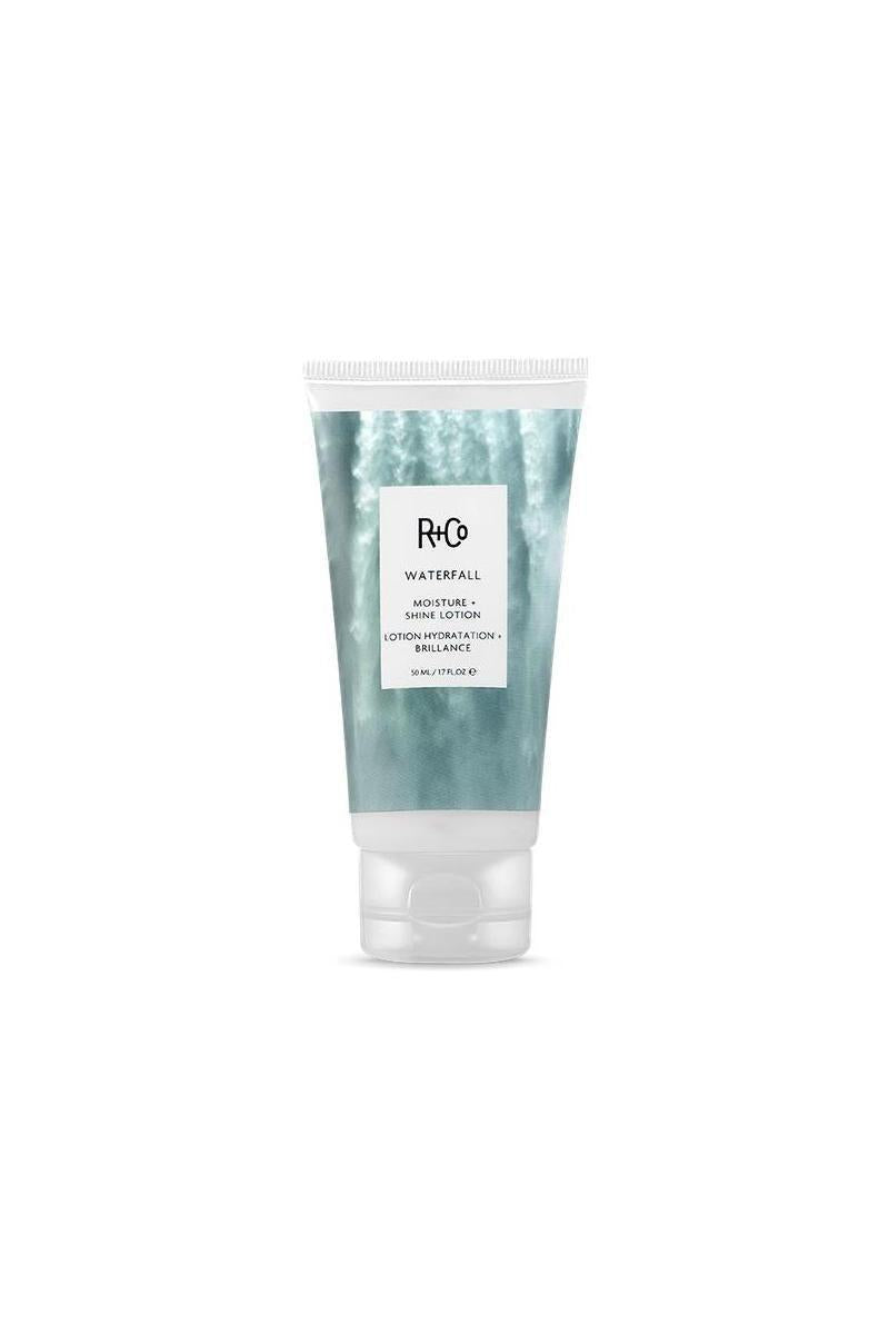 R+Co Waterfall Moisture & Shine Lotion in a white tube with a blue waterfall design and clear cap.