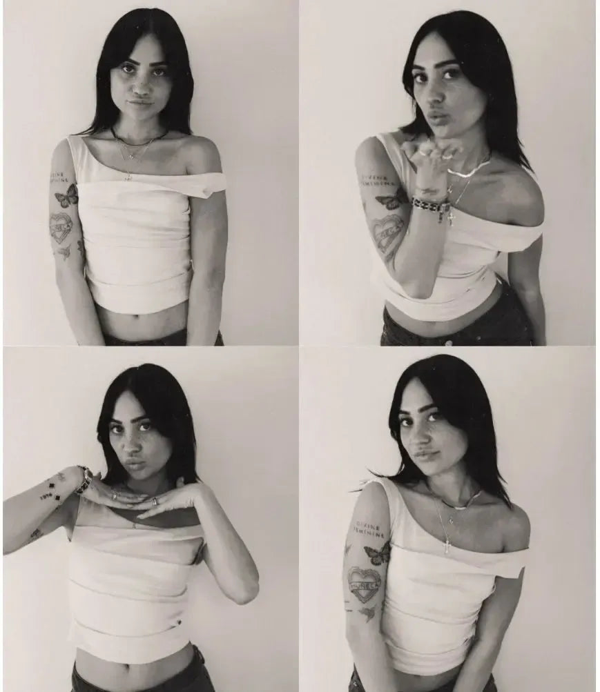 Maia Sotelo modeling a chic off-the-shoulder top, showcasing her unique style and tattoos.