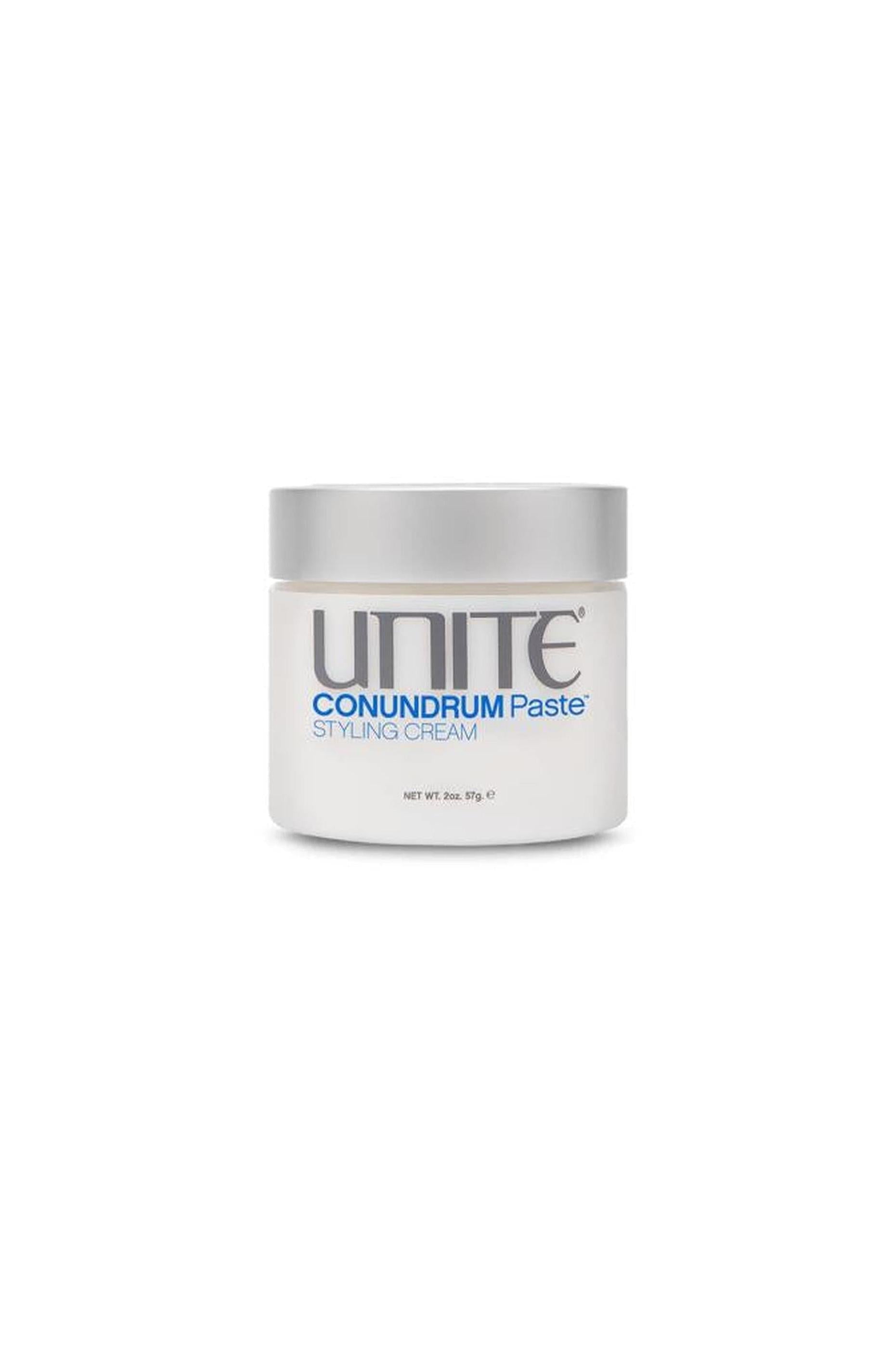 White Unite Conundrum Paste styling cream, 2oz jar with a silver lid and blue text.
