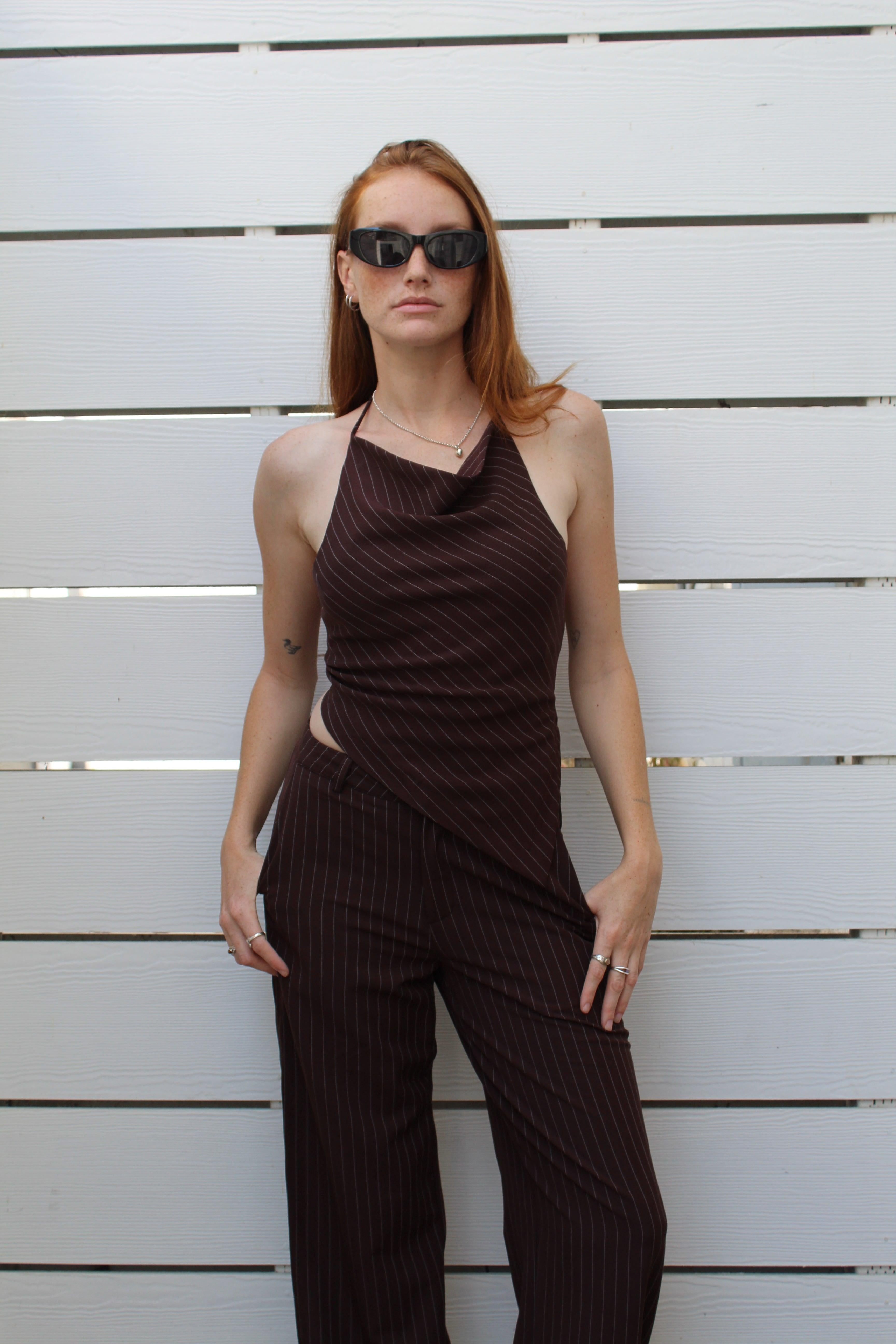 Model in a brown pinstriped halter top and matching wide-leg pants, size S, against a white wall.